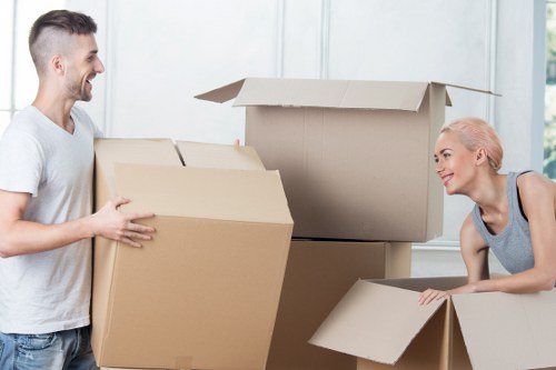 Removal team handling furniture and boxes in a Kingston home