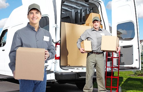 Loading furniture and boxes into a moving van for transport